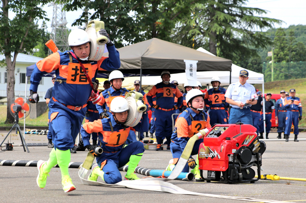 小型ポンプの放水準備を行う消防団員の画像